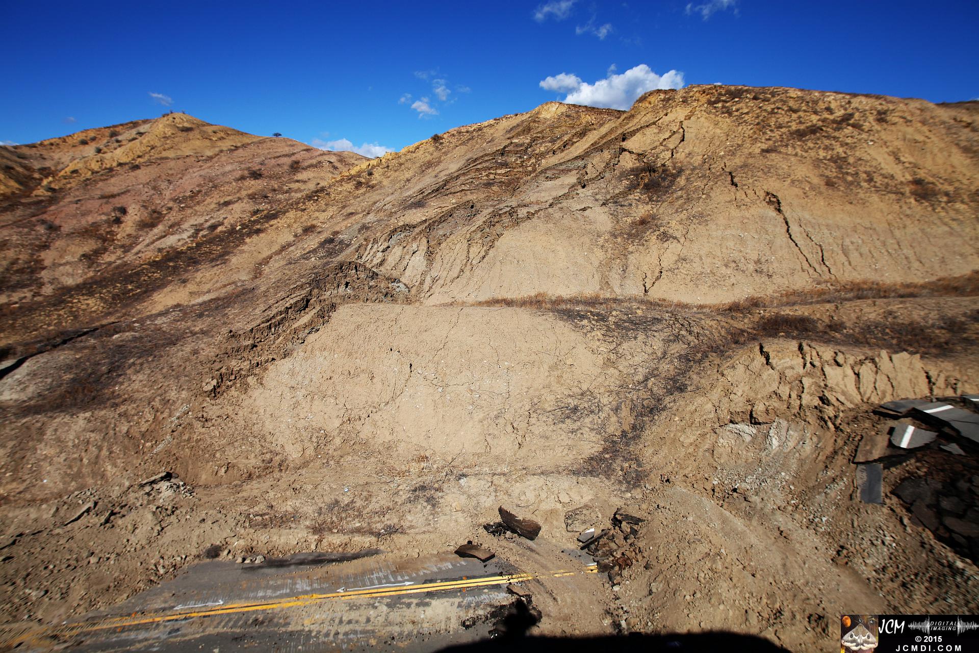 Landslide, buckled pavement, and terrain at Vasquez Canyon Road in Santa Clarita, CA filmed 11-25-2015